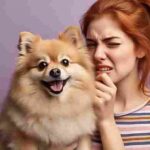 Woman reacting to her dog’s bad breath with a disgusted expression