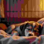 Sleepy puppy resting inside a crate at night with soft bedding